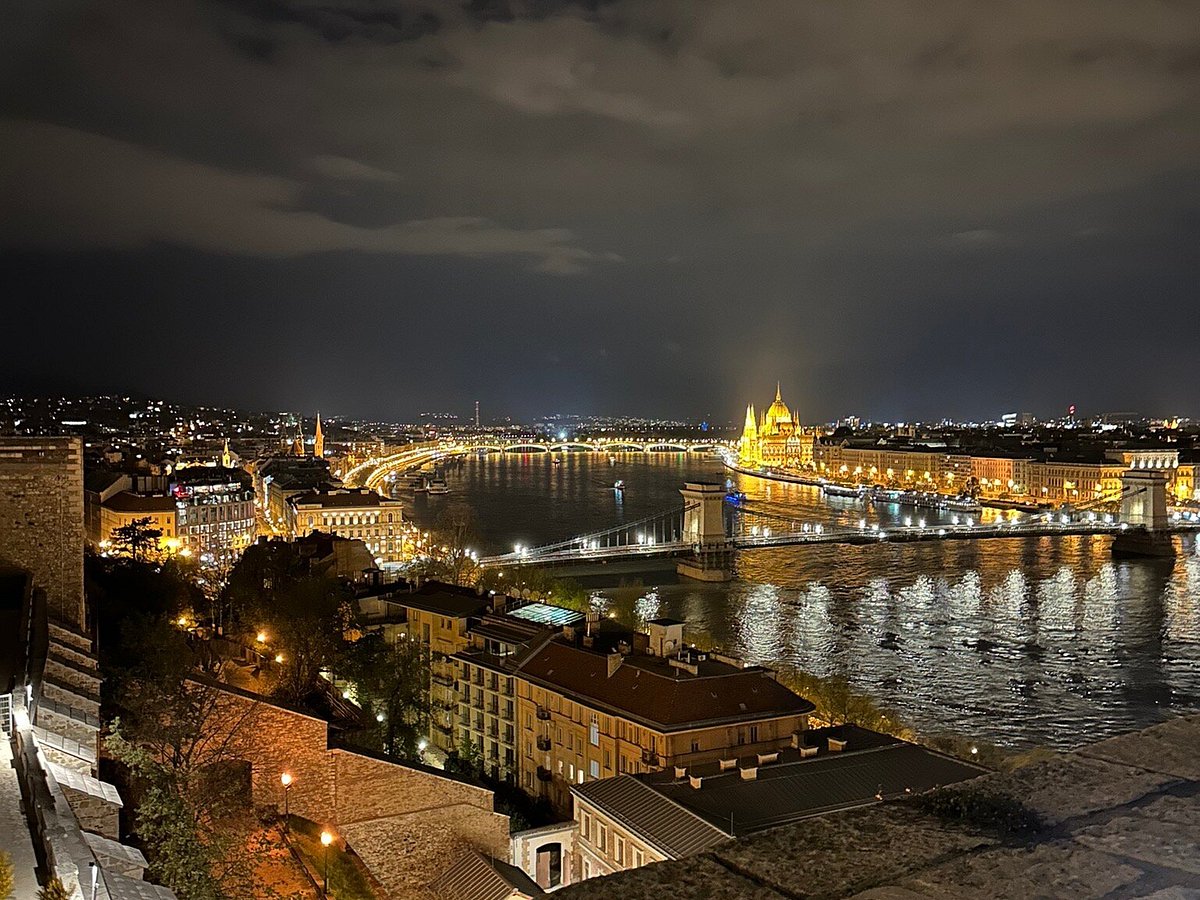 A bustling European city street at dusk.